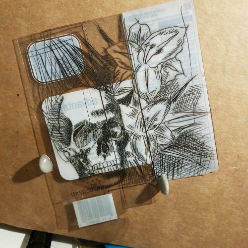 plastic package etched with skull and daylilies image