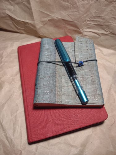 2 notebooks and a fountain pen laid out for display